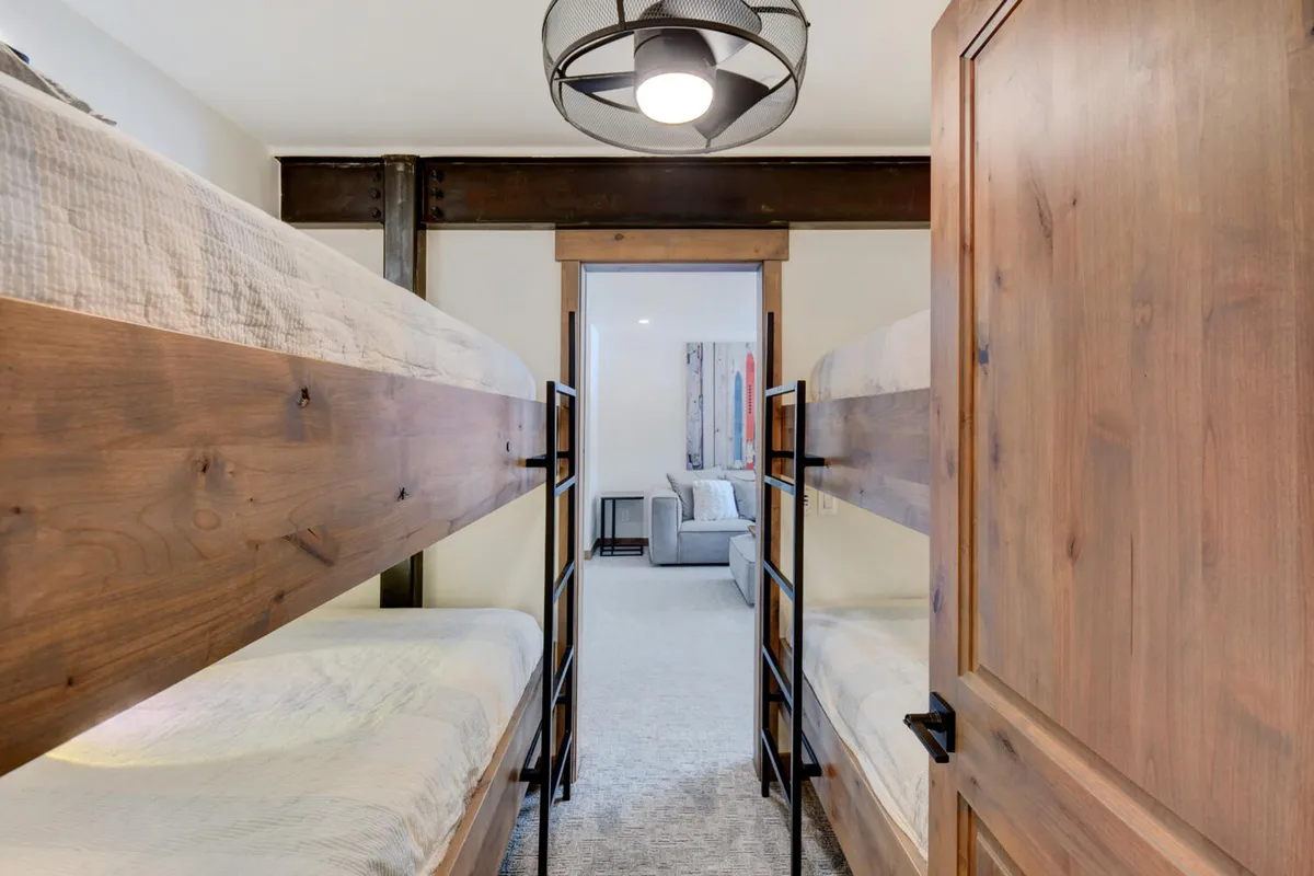 A playful bunk room with sturdy bunk beds and a welcoming ambiance. The space feels relaxed and fun, ideal for kids or groups sharing lasting memories during their stay.